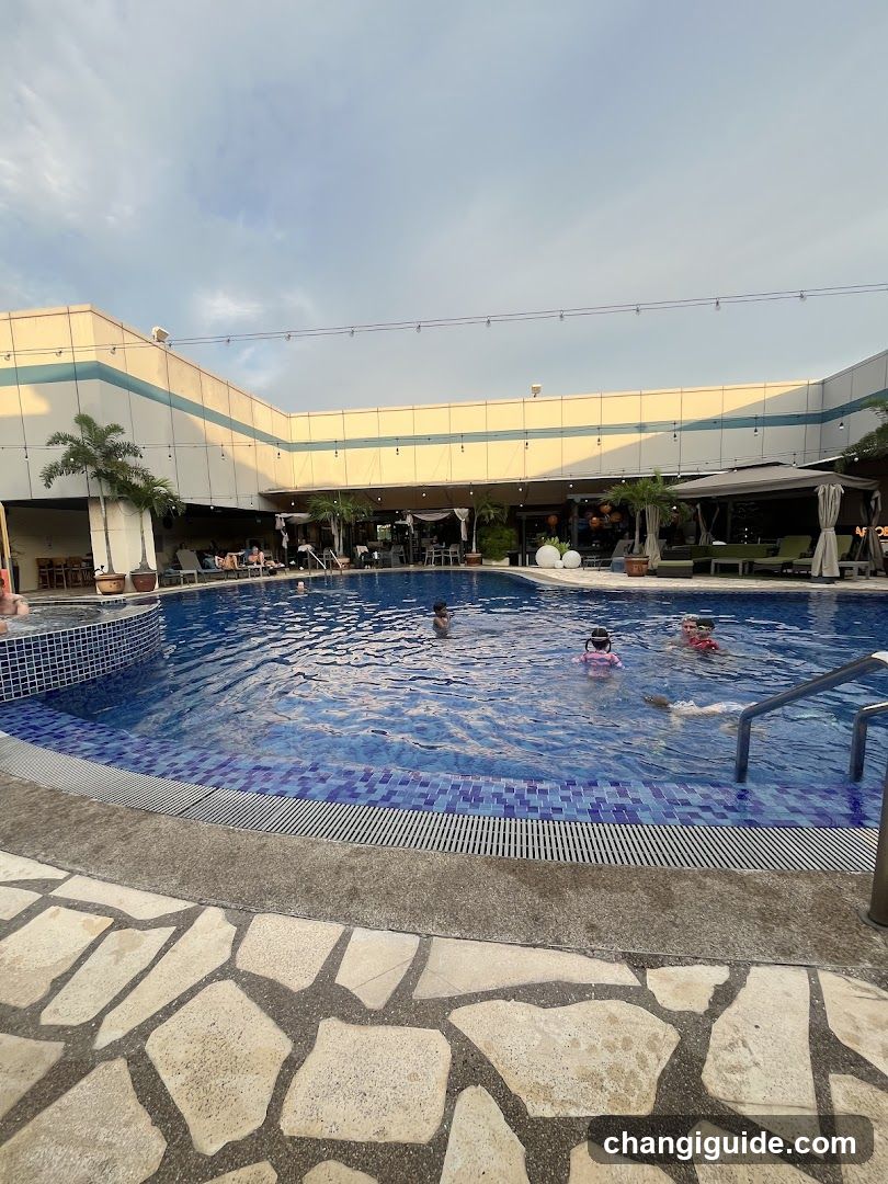 Poolside Scene with Children Swimming