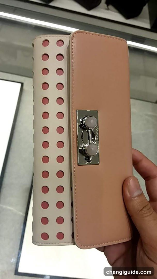 Handheld clutch purse with perforated design