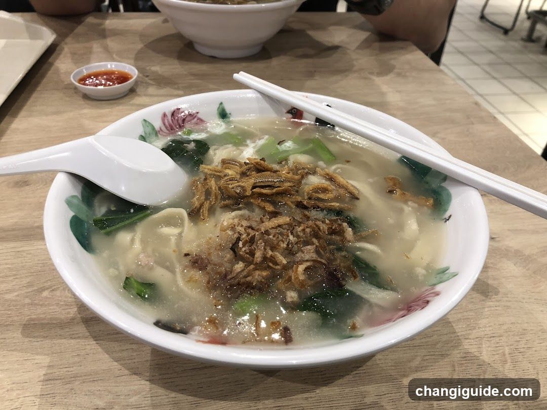 Bowl of Noodle Soup with Chopsticks and Spoon