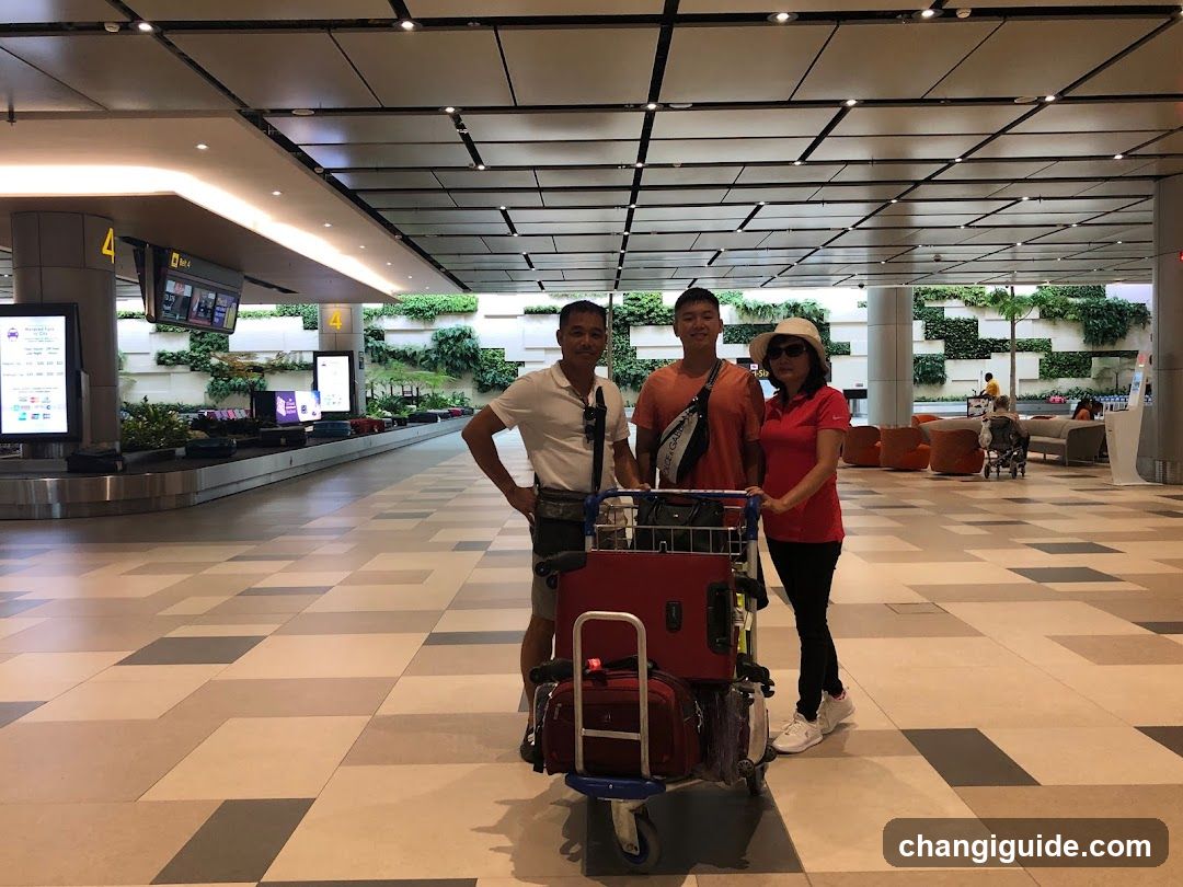 Airport Terminal Interior with Travelers and Luggage Cart