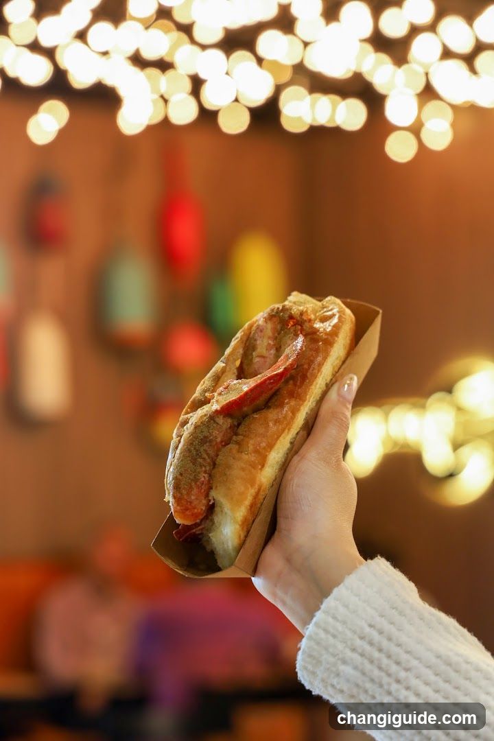 Hand Holding a Gourmet Sandwich