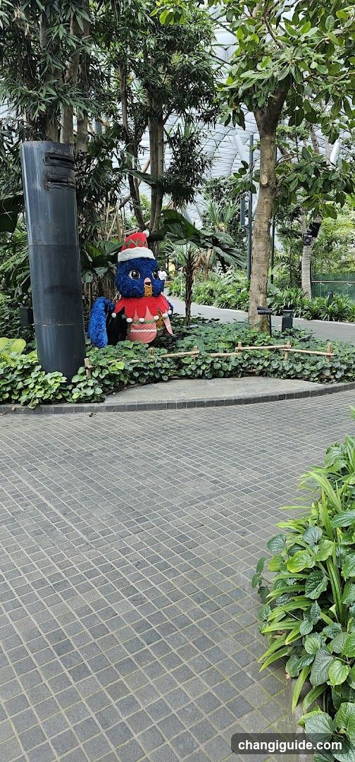 Christmas-themed bird statue in garden