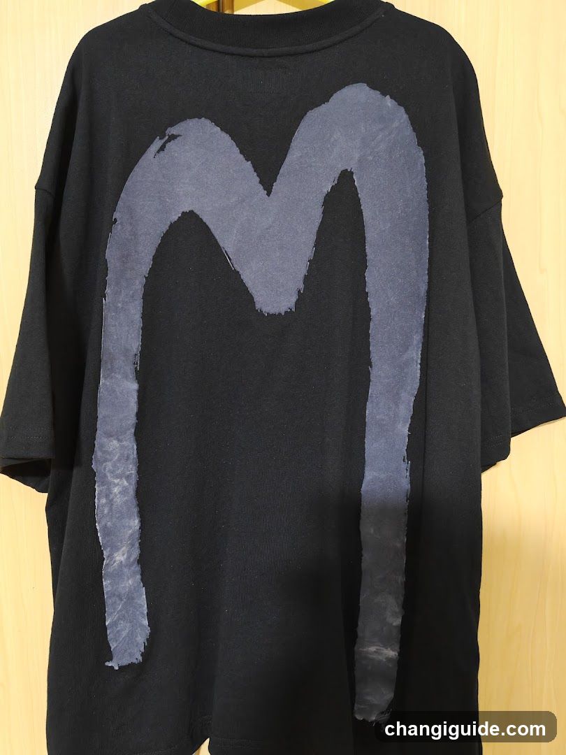 Black T-Shirt with Grey 'M' Graphic