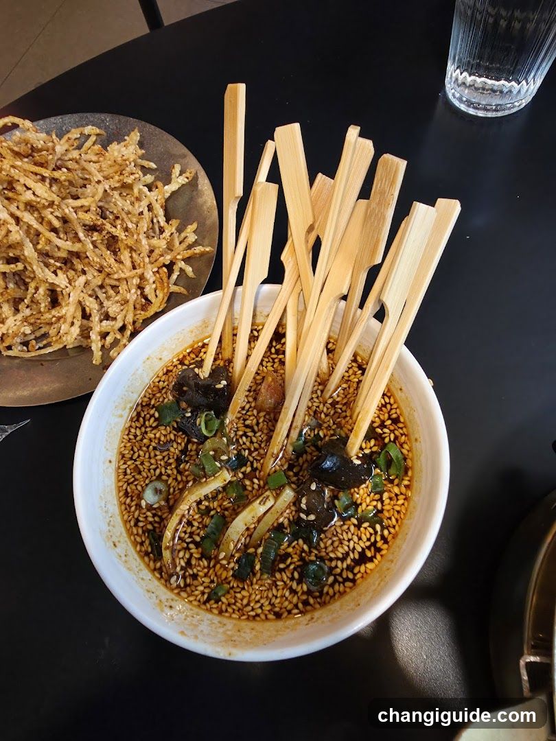 Spicy Sesame Bowl with Skewers and Fried Snacks