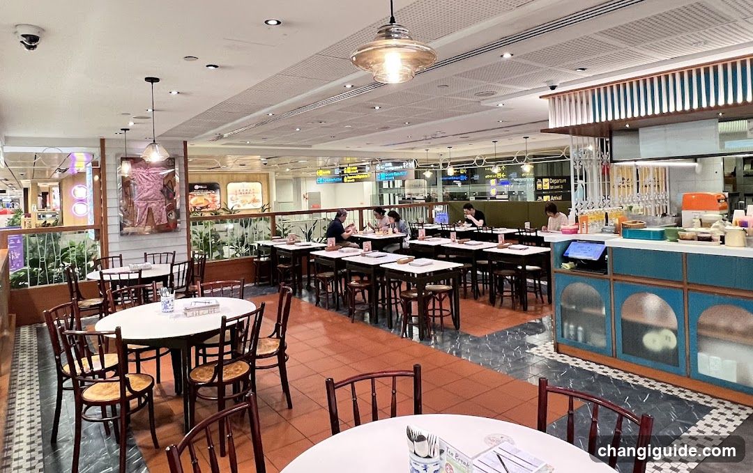 Restaurant Interior with Dining Tables and Kitchen Area