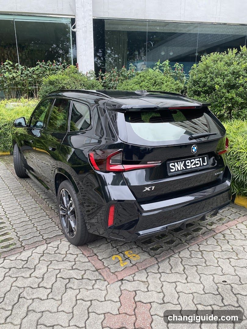 Black BMW X1 parked outside building