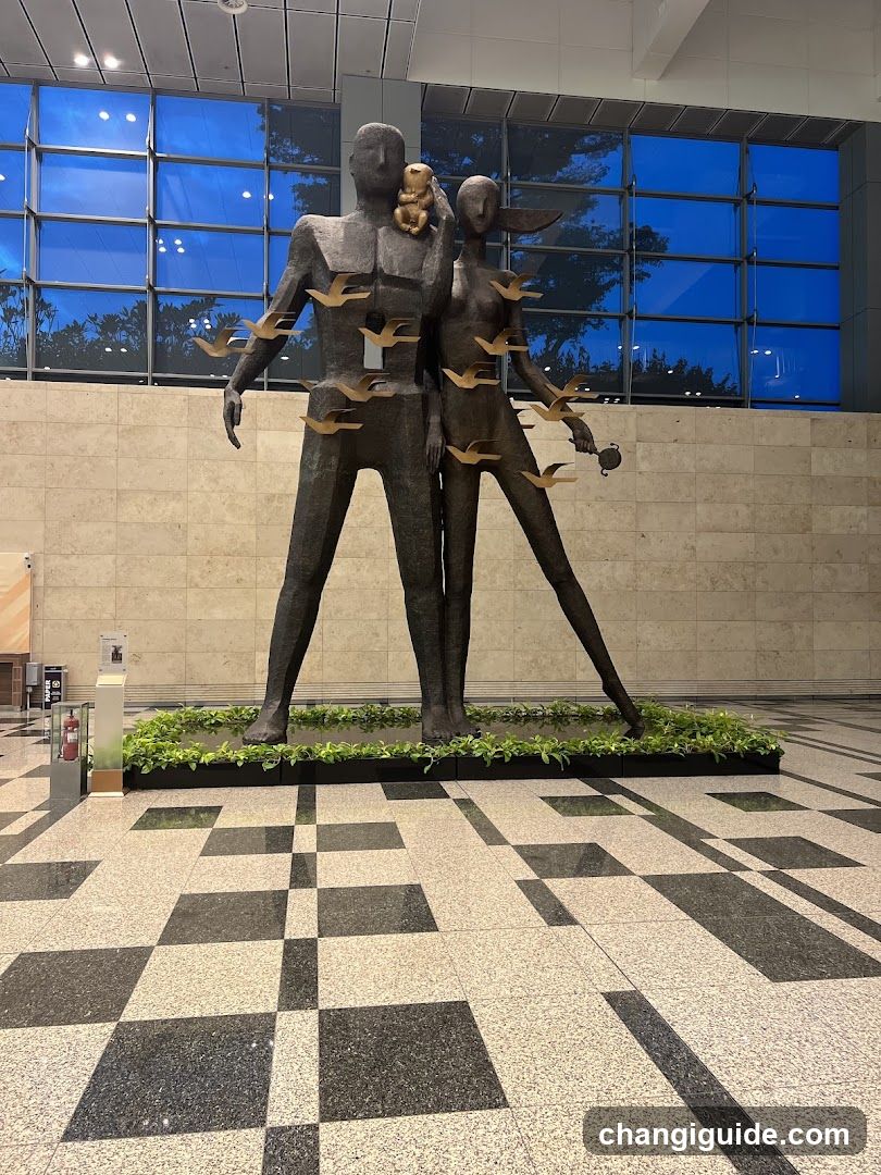Statue of Two Figures with Birds