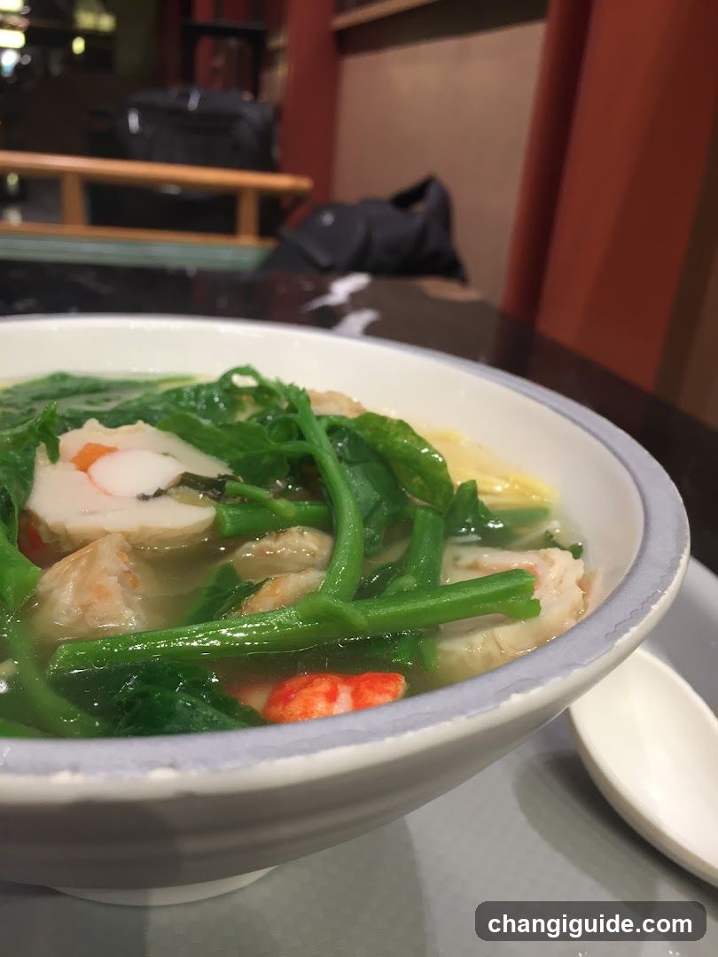 Bowl of Soup with Greens and Seafood
