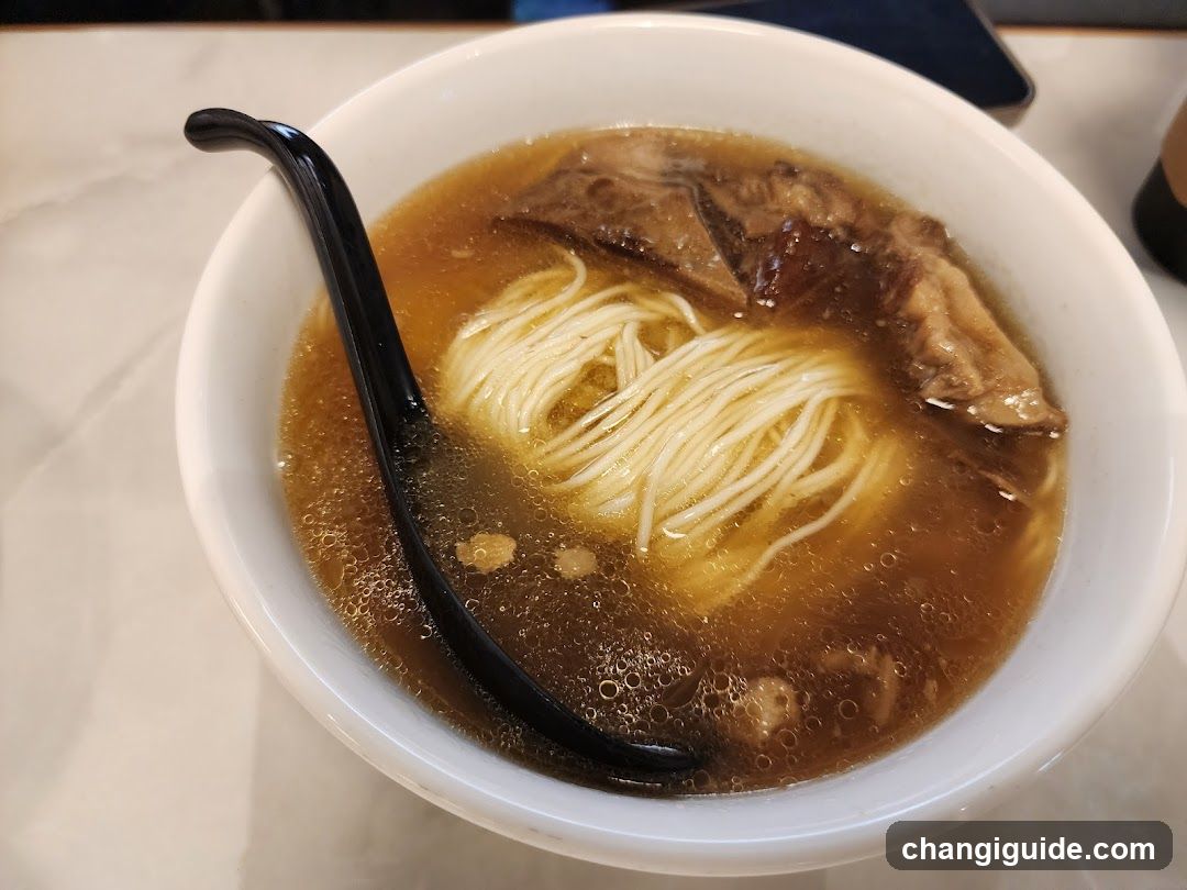 Bowl of Noodle Soup with Black Chopsticks
