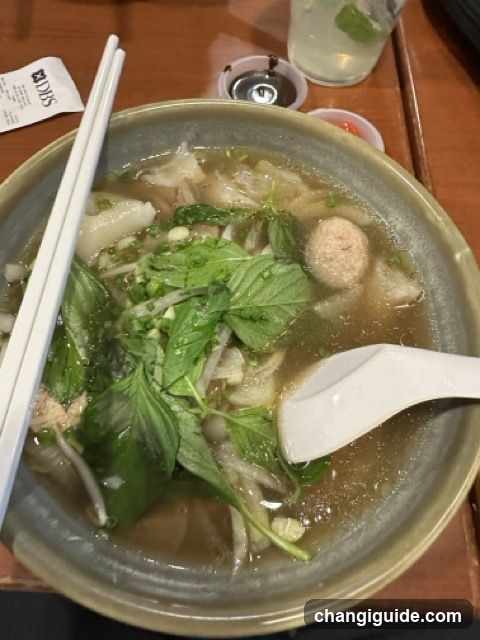 Bowl of Soup with Basil and Meatballs
