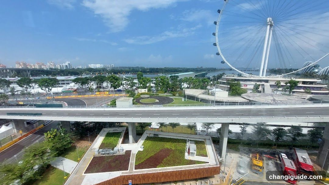 Elevated view of Singapore waterfront with Ferris wheel and elevated walkway