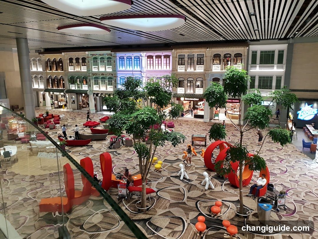 Shopping Mall Interior with Decorative Trees and Seating Areas