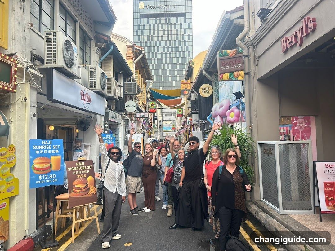 Street scene with group of people posing in a narrow alleyway