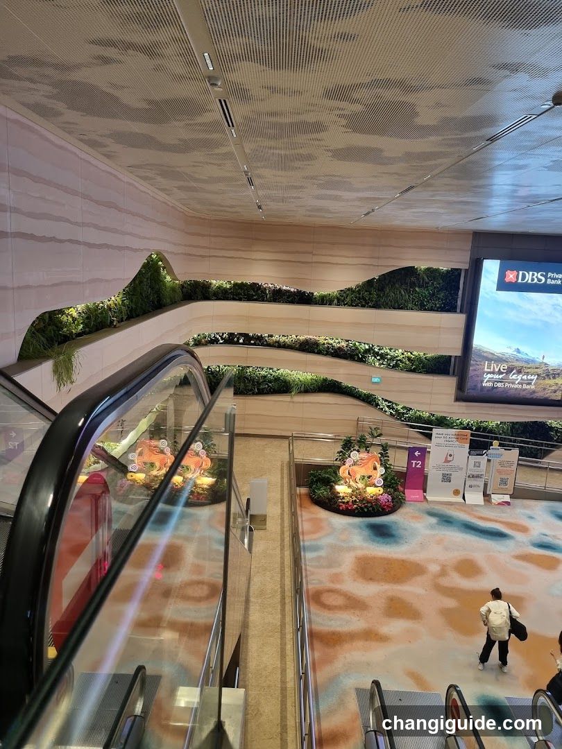 Indoor Shopping Area with Escalator and Green Wall