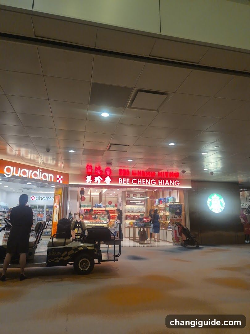 A storefront featuring a brightly lit 'BEE CHENG HIANG' sign with Chinese characters above it, displaying various packaged goods through glass windows and doors. Adjacent to the left is a 'guardian' pharmacy entrance, while to the right, a Starbucks logo is visible on the wall.