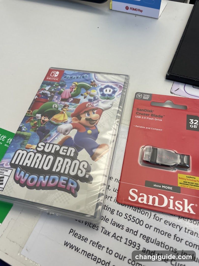 Super Mario Bros Wonder and SanDisk Flash Drive on table