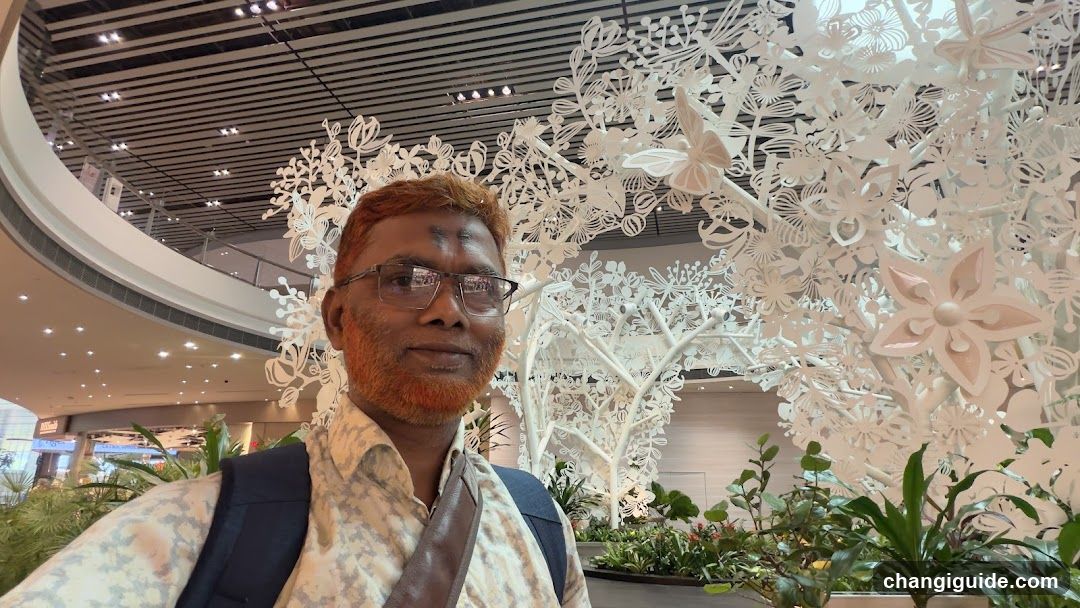 Man in Airport Terminal with Art Installation