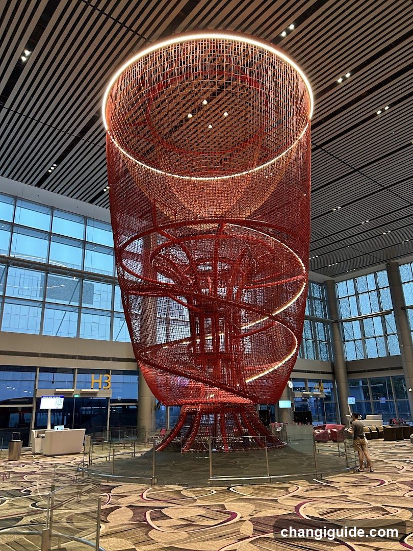 Red Spiral Sculpture in Airport Terminal