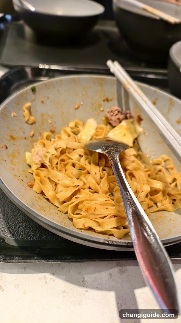 Noodle Dish with Chopsticks and Spoon