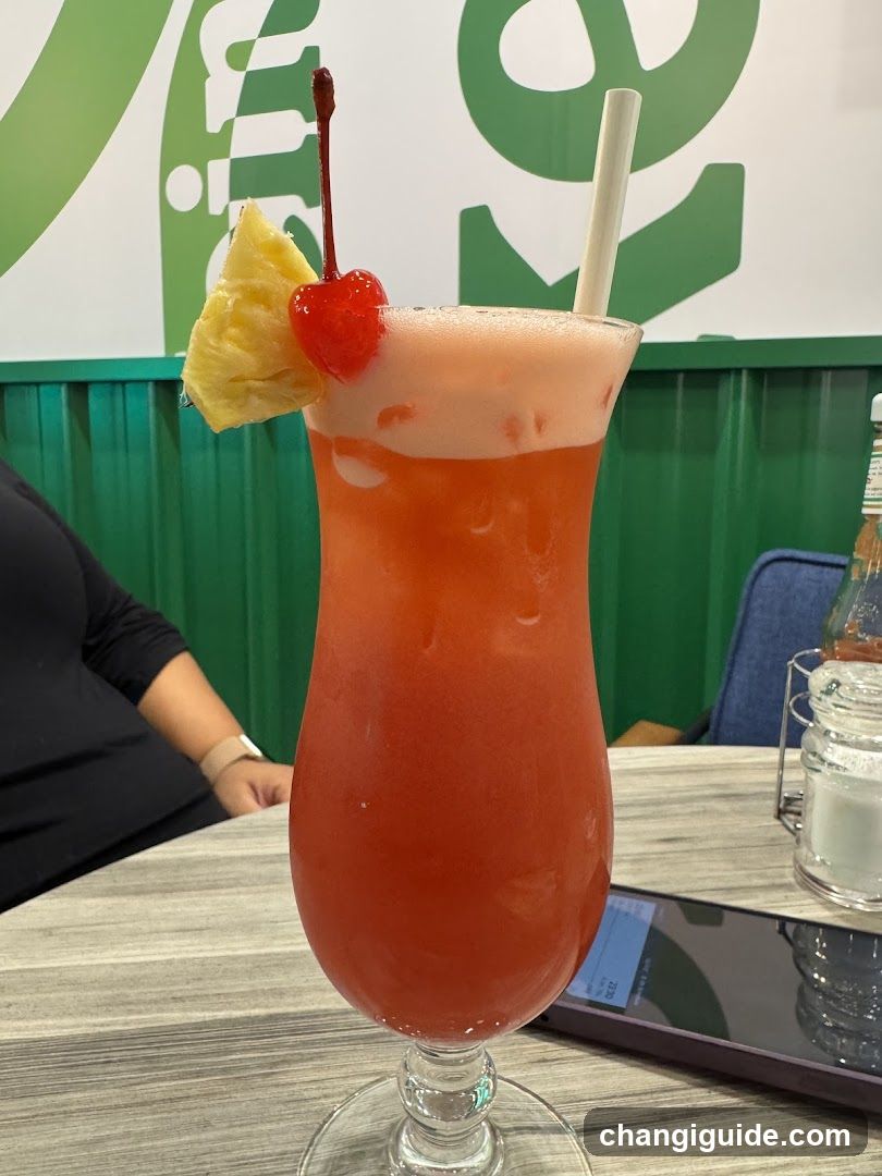 Pink Cocktail with Pineapple and Cherry Garnish
