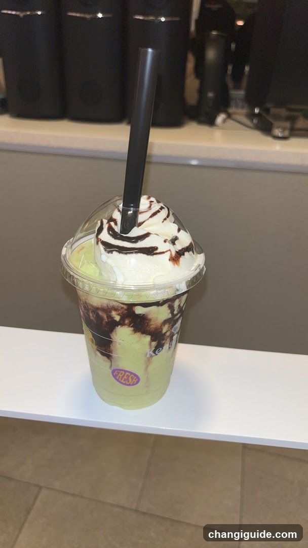 Iced Matcha Frappuccino with Whipped Cream and Chocolate Drizzle