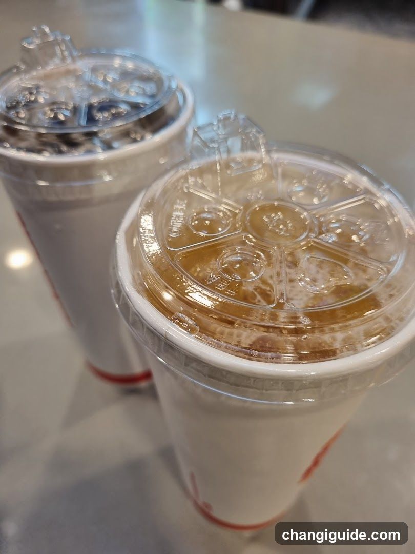 Two iced beverages in plastic cups