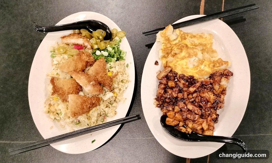 Two plates of fried rice with toppings