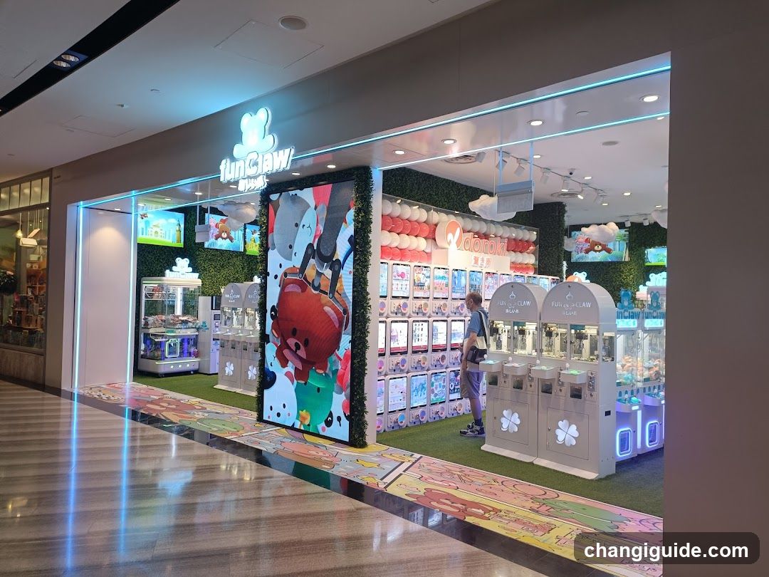 A brightly lit claw machine arcade store with a large illuminated sign reading 'funClaw' above the entrance. The facade features greenery walls, colorful posters of cartoon characters, and multiple claw machines arranged in rows. A person is standing near one of the machines. The floor has decorative flooring with cartoon designs.