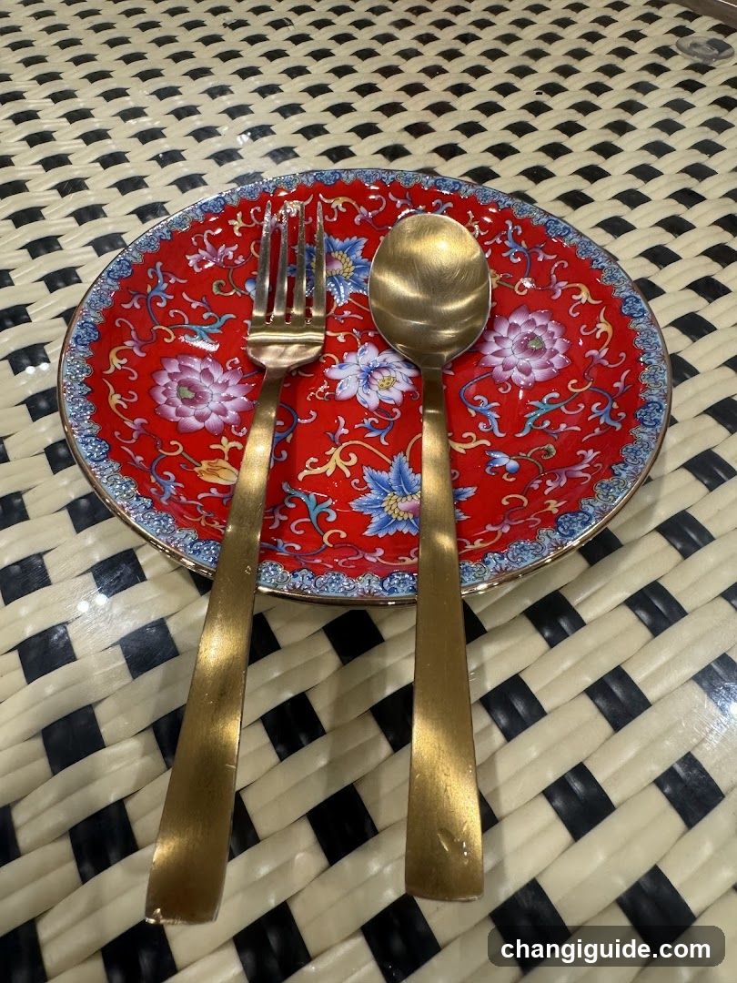 Red Patterned Plate with Gold Cutlery