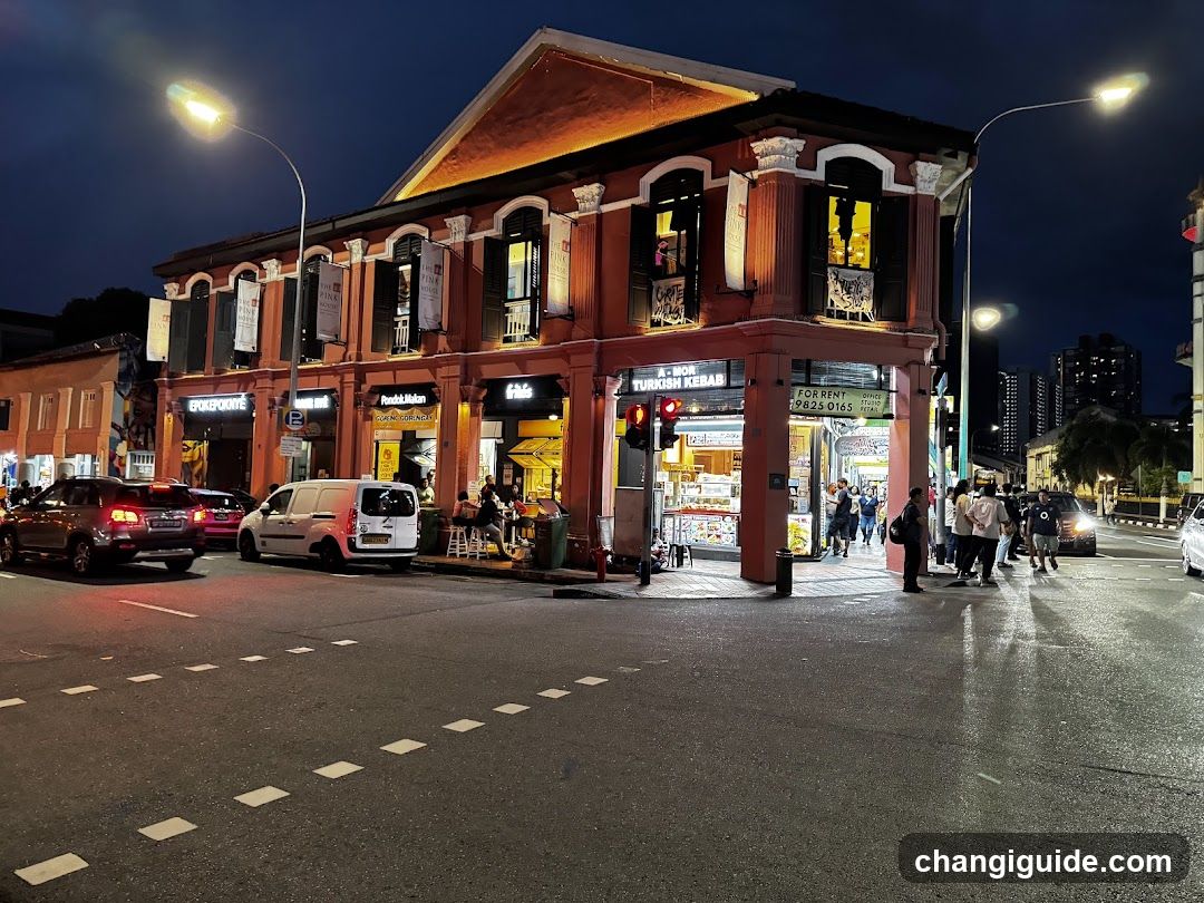 Night street scene with illuminated shop fronts