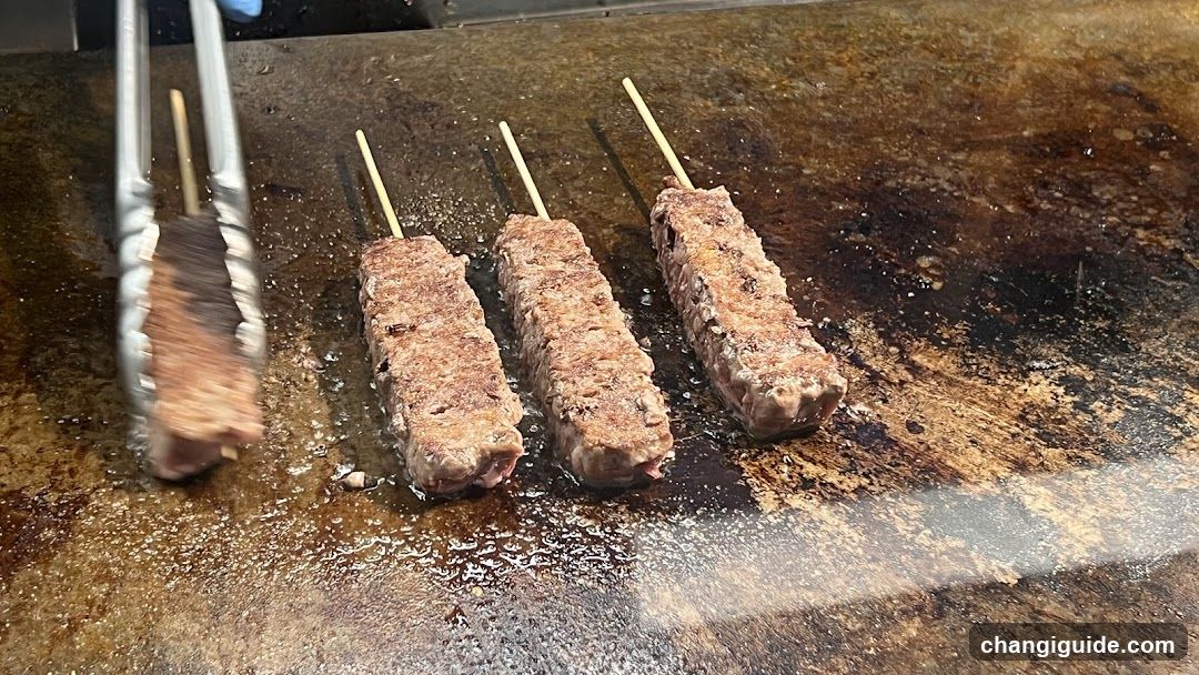 Grilled Meat Skewers on a Hot Plate