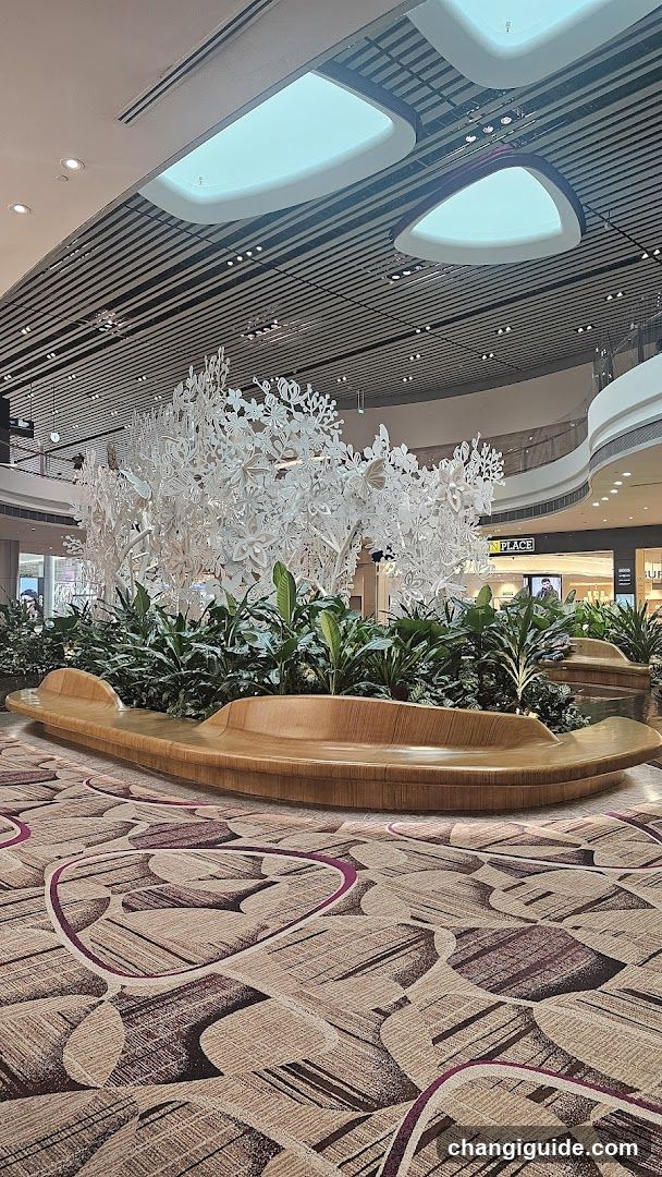 Shopping Mall Interior with Decorative Tree and Seating Area