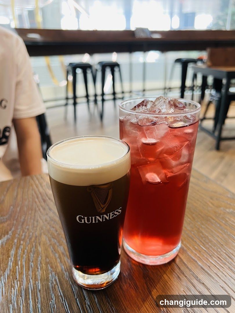 Guinness and Red Drink on Table