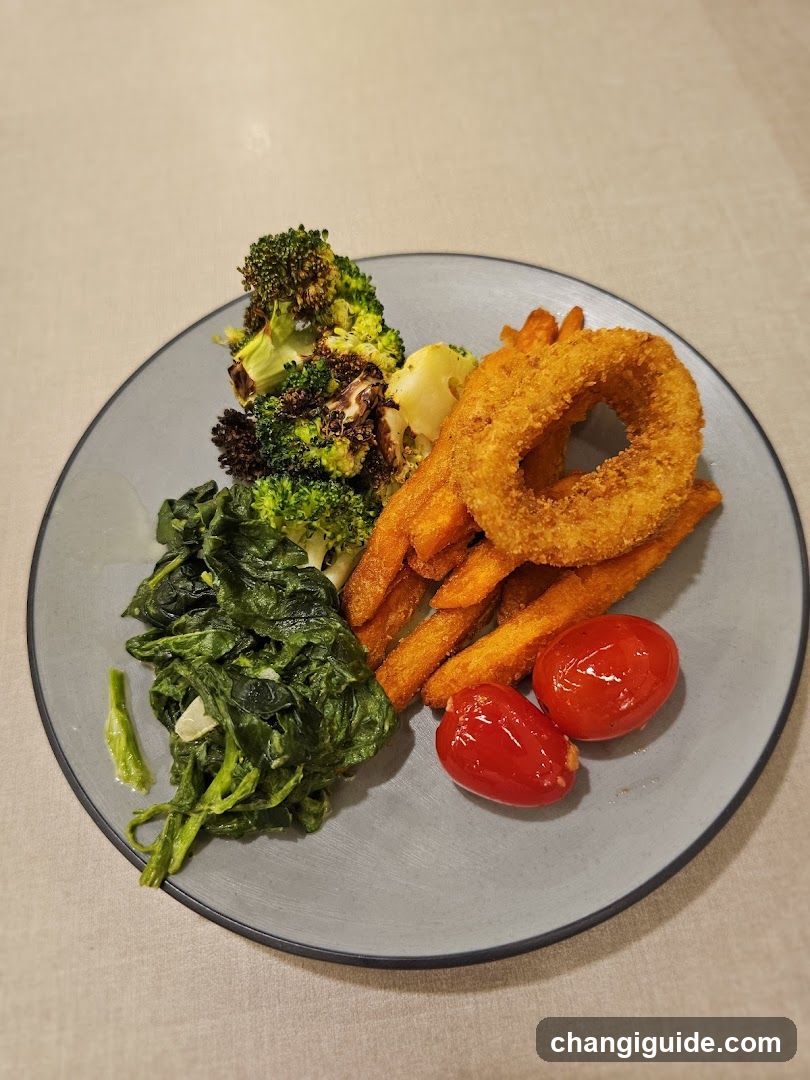Plate of Food with Broccoli, Sweet Potato Fries, Onion Rings, Spinach and Cherry Tomatoes