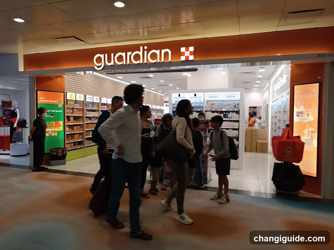 A photo of the physical exterior entrance to a Guardian store, featuring prominent orange and white signage with the 'guardian' logo and cross symbol above the glass doors. Several people are standing near or entering the store. Inside, shelves stocked with products like Avene skincare items are visible. Red shopping bags rest on the floor outside.