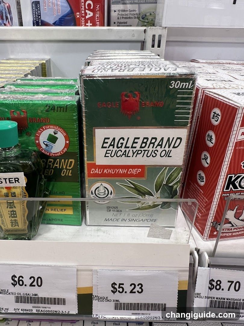 A shelf display in a store featuring Eagle Brand Eucalyptus Oil (30ml) prominently placed next to other health and wellness products like massage oils and pain relief creams. Price tags show $5.23 for the eucalyptus oil.