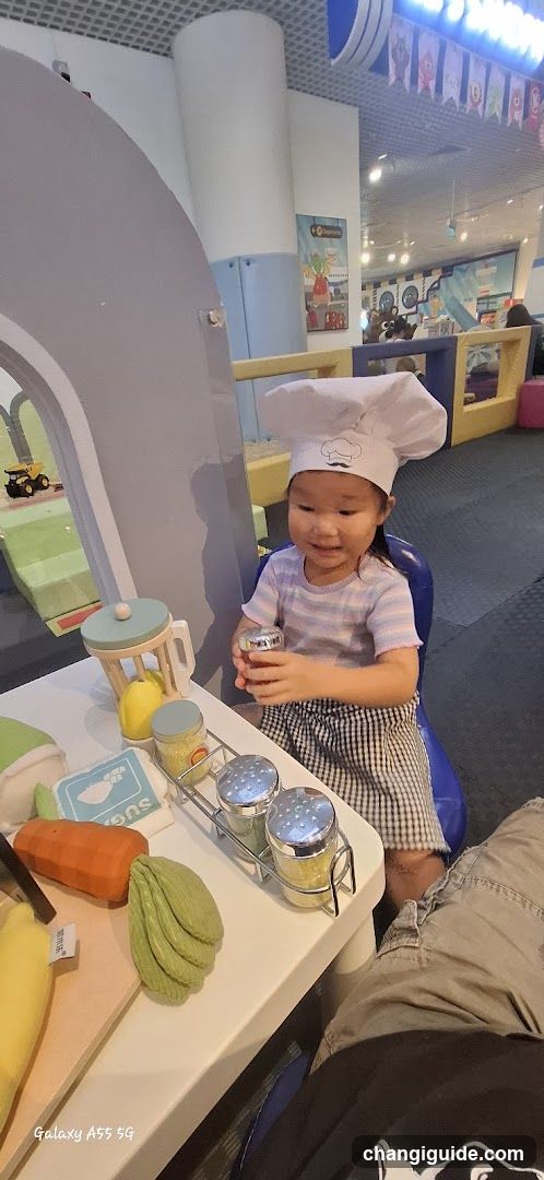 Child in Chef Hat at Play Kitchen