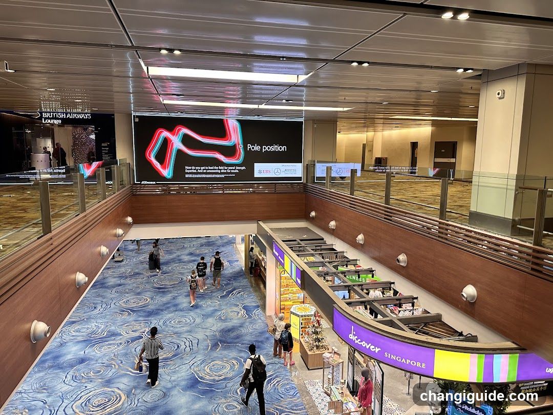 Airport Terminal Interior with Digital Display and Retail Area