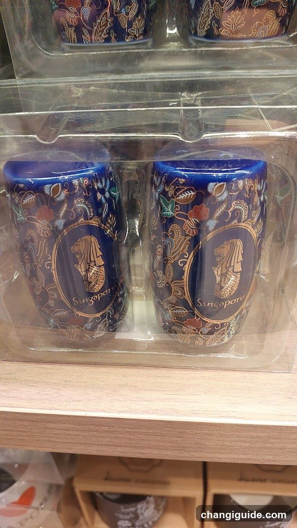 Singapore-themed mugs on display shelf