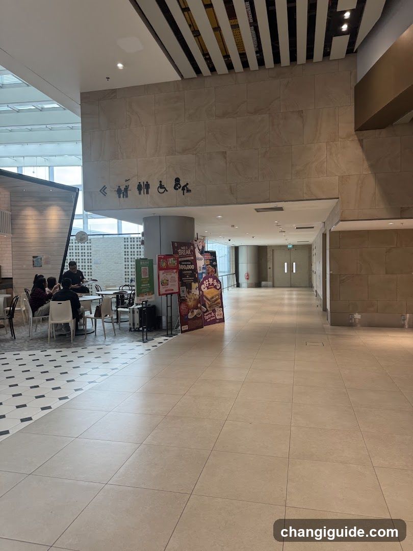 Interior of a modern building with seating area and signage