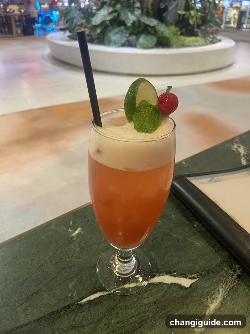 Cocktail with Lime and Cherry Garnish