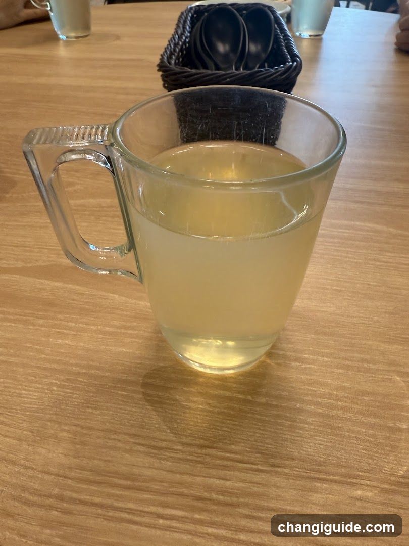 Glass Mug with Light Yellow Liquid on Wooden Table