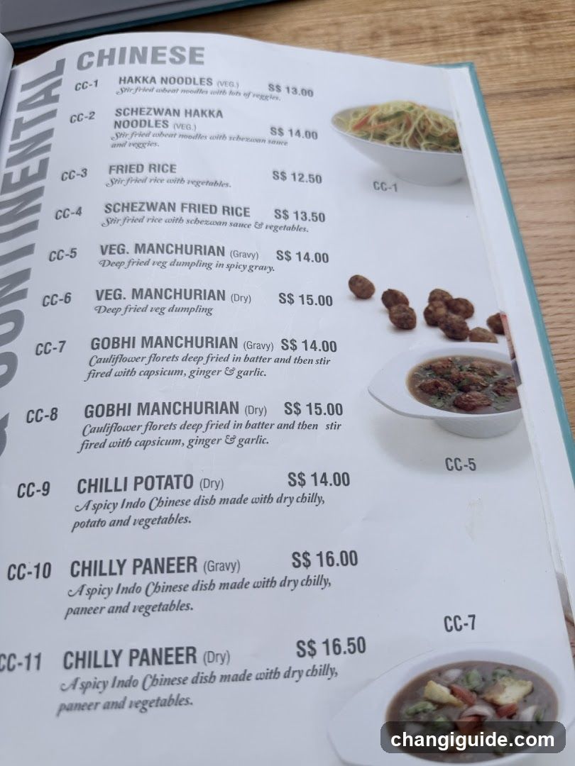 A printed menu page from a Chinese restaurant showing items like Hakka Noodles, Fried Rice, Manchurian dishes, and Chilly Paneer with prices in SGD.