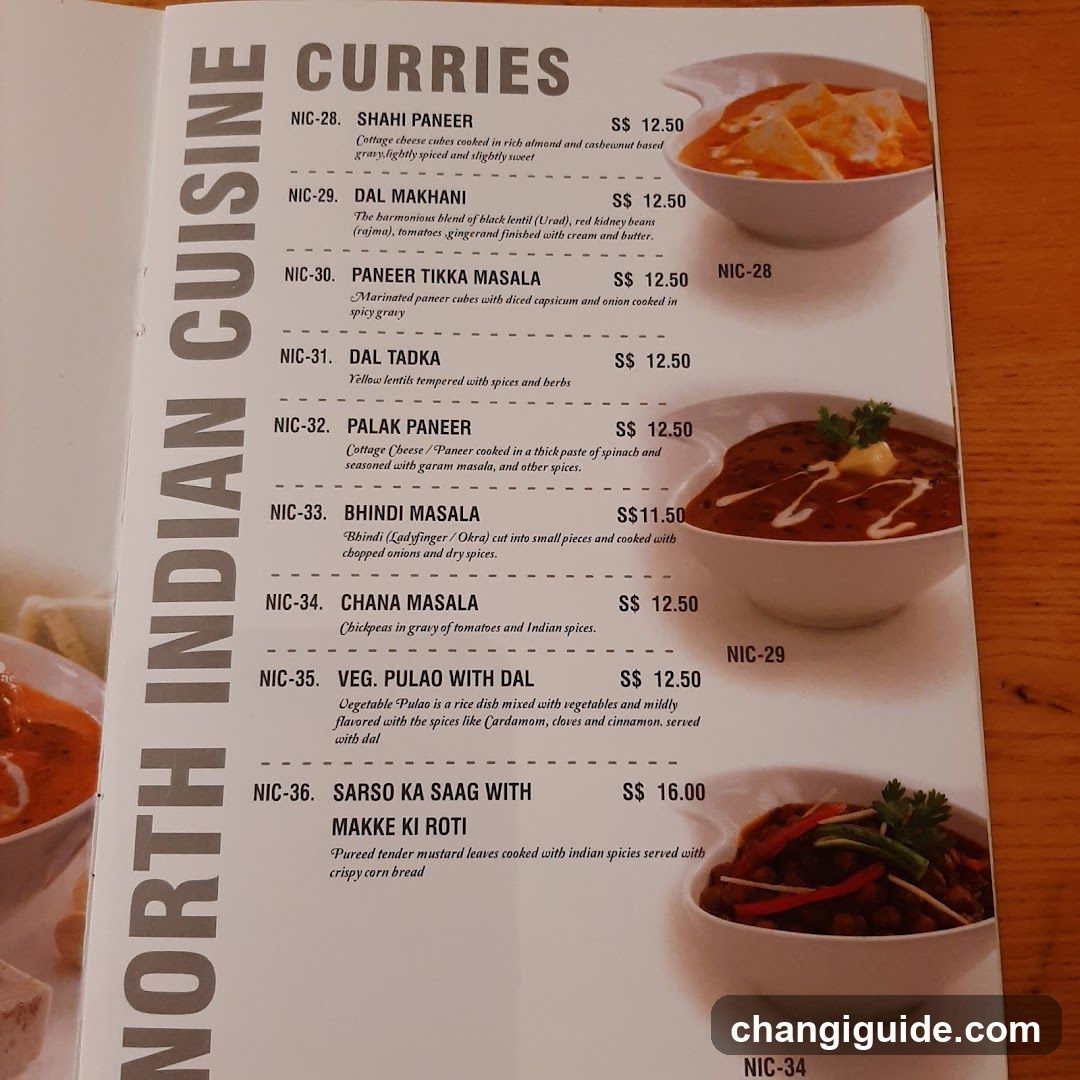 A printed menu page from a restaurant featuring North Indian dishes, including curries like Shahi Paneer, Dal Makhani, and Palak Paneer, with prices listed in dollars.