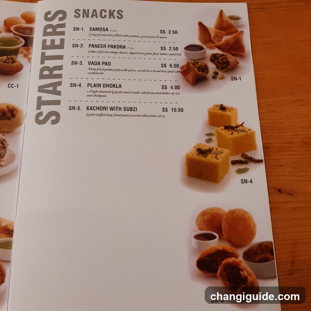 A printed menu page featuring a list of snack items with descriptions and prices, accompanied by photos of the food.