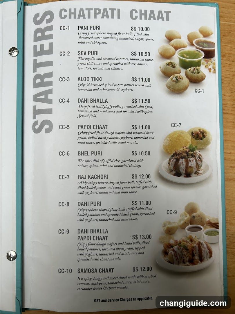 A printed menu page featuring a list of Indian street food items with descriptions and prices, including Pani Puri, Sev Puri, Aloo Tikki, Dahi Bhalla, Papdi Chaat, Bhel Puri, Raj Kachori, Dahi Puri, Samosa Chaat, and others.