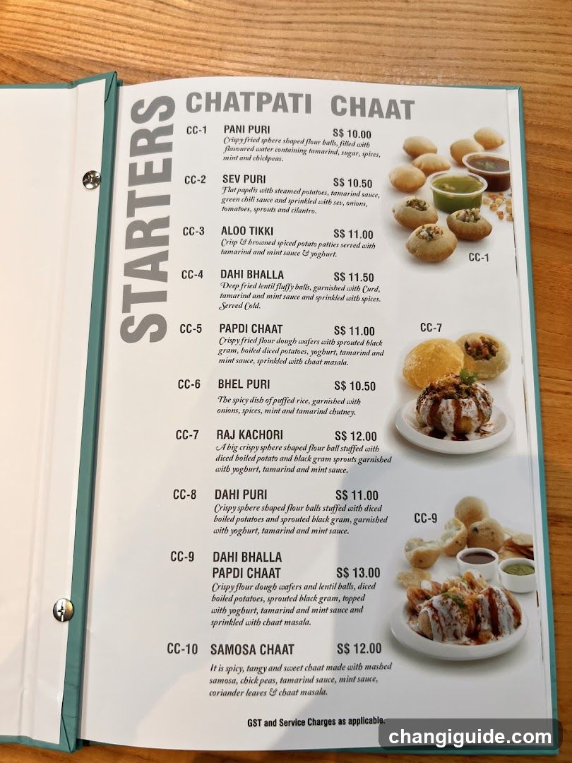 A printed menu featuring Indian street food items like Pani Puri, Sev Puri, Aloo Tikki, Dahi Bhalla, Papdi Chaat, and Samosa Chaat with prices in SGD.
