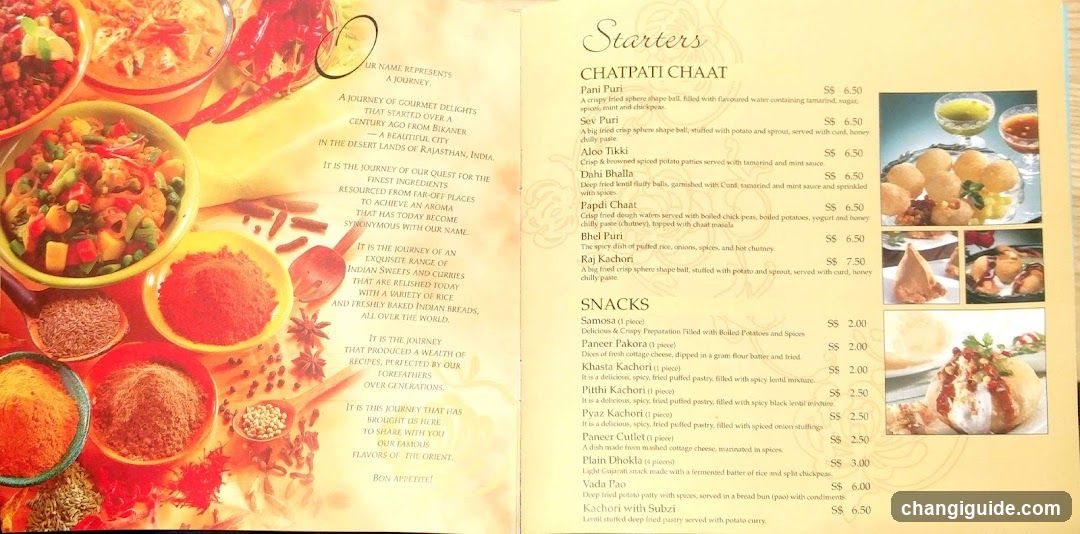 A printed menu featuring a left page with an artistic illustration of Indian spices and sweets, alongside a poetic introduction to Rajasthani cuisine. The right page lists starters (Chapati Chaat) and snacks with prices in USD.