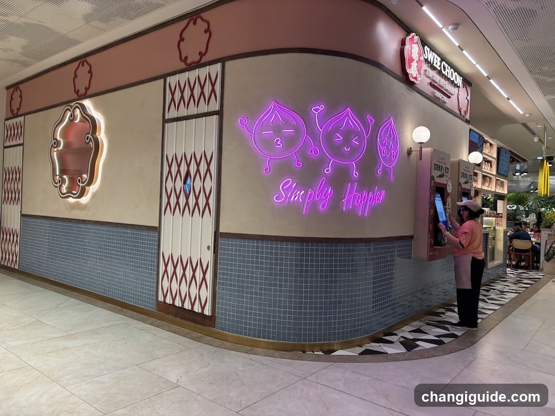 A corner storefront with pink and beige walls, featuring neon purple characters and the phrase 'Simply Happier' in cursive. A self-service kiosk is visible on the right side.