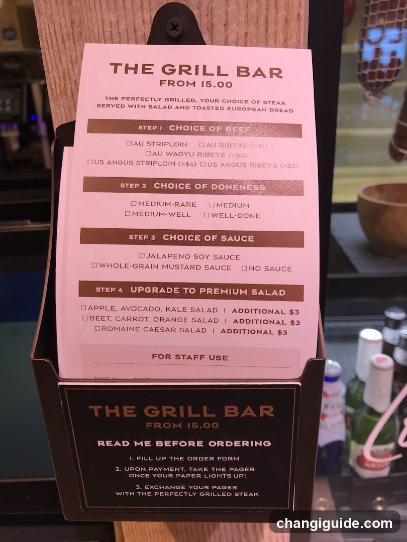 A pink paper menu displayed in a wooden stand, detailing the 'Grill Bar' steak selection process with beef choices, doneness options, sauces, and salad upgrades.